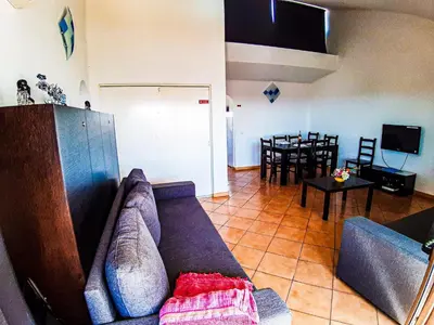 a living room with a couch and a tv at Vilamagna Apartment 501 - By Algarkasa in Albufeira