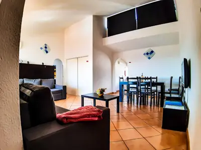 a living room with a couch and a table at Vilamagna Apartment 501 - By Algarkasa in Albufeira