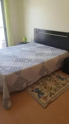 a bedroom with a bed and a rug on the floor at Plaza 305 Albufeira in Albufeira
