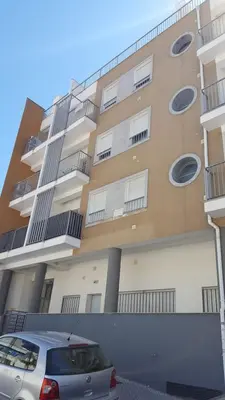 a building with a car parked in front of it at Plaza 305 Albufeira in Albufeira