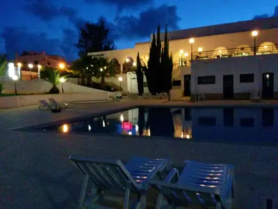a bedroom with a bed with colorful sheets and pillows at Rialgarve in Faro