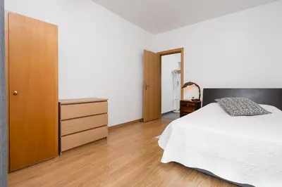 a bedroom with a bed and a wooden dresser at Casa Gago in Faro