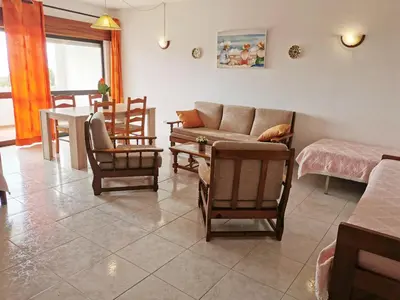 a living room with a couch and chairs and a table at Vista Mar 2 in Albufeira