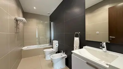 a bathroom with a toilet and a sink and a tub at Cavalo Prеto Holiday apartment 200m to the beach in Quarteira
