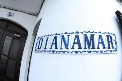 a living room with a couch and a chair at Guest House Dianamar in Albufeira