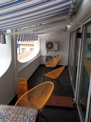 a room with two chairs and a table and a window at Edifício Albufeira 406 in Albufeira