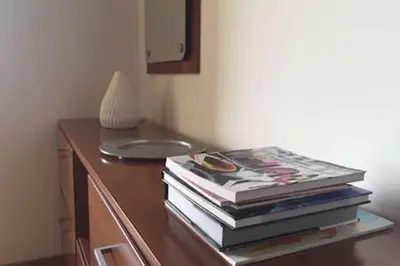 a stack of books sitting on top of a table at Your place in Faro in Faro
