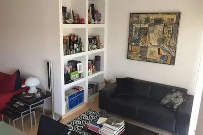 a living room with a couch and a book shelf at Your place in Faro in Faro