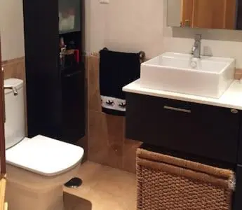 a bathroom with a white toilet and a sink at Your place in Faro in Faro