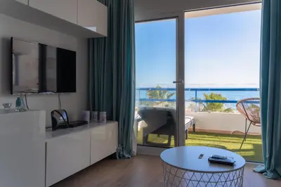 a living room with a view of the ocean at Apartamento Deluxe AM in Quarteira