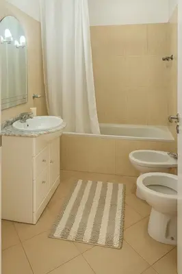 a bathroom with a sink and a toilet and a tub at sol nascente in Vilamoura