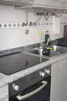 a kitchen with a stainless steel sink and a counter at AL - Comfortable House in Faro