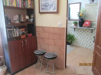 a room with two stools and a book shelf at Guest House Capitao Mor in Faro