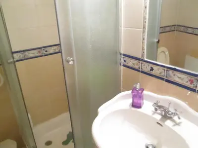 a bathroom with a sink and a shower at Guest House Capitao Mor in Faro