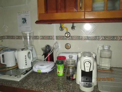 a kitchen counter with many appliances on it at Guest House Capitao Mor in Faro