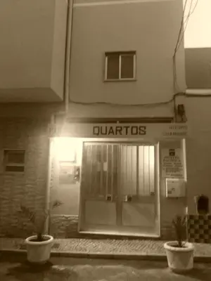a store front with two potted plants in front of it at Guest House Pacifica in Quarteira