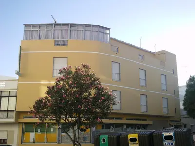 two cars parked in front of a building at Guest House Pacifica in Quarteira