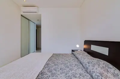 a bedroom with a large bed in a room at Cavalo Preto Beach Resort in Quarteira