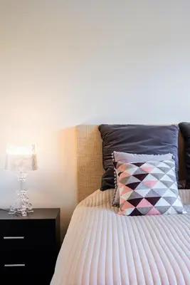 a bedroom with a bed with a pillow and a nightstand at L'Orangerie in Vilamoura