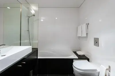 a white bathroom with a sink and a toilet at L'Orangerie in Vilamoura
