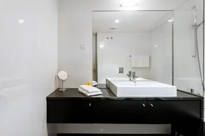 a bathroom with a white sink and a mirror at L'Orangerie in Vilamoura