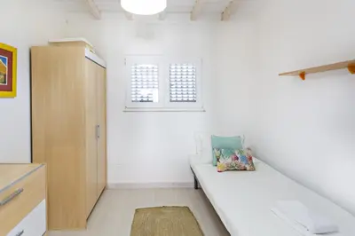 a white room with a couch and a window at Villa Lydia in Faro