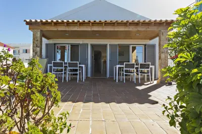 a patio with a table and chairs on it at Villa Lydia in Faro