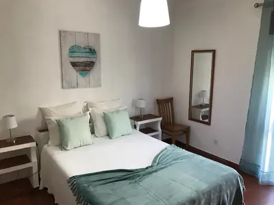 a bedroom with a white bed and a mirror at BREEZY NEST by ITHOUSE in Albufeira