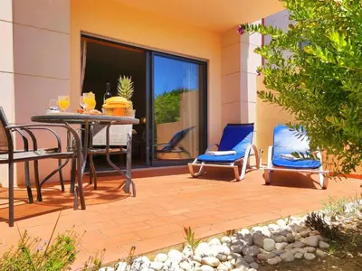 a patio with a table and chairs on a patio at Fabulous Sunny Pool&Garden Condo by BeCherish in Albufeira