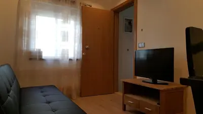 a living room with a television and a couch at Apartamento Cardoso II. A 5 minuto a pé da praia do Peneco in Albufeira