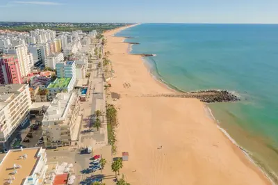 an aerial view of a beach with buildings and the ocean at Sea Studio in Quarteira