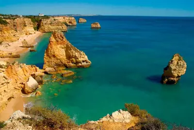 a view of a beach with rocks in the water at Vilamoura Charming Apartment by Intiholidays in Vilamoura