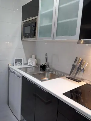 a small kitchen with a sink and a microwave at Panoramic Sea View 1 Bedroom Apartment in Albufeira