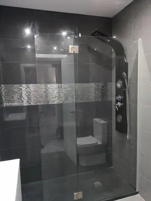 a glass shower with a toilet in a bathroom at Panoramic Sea View 1 Bedroom Apartment in Albufeira
