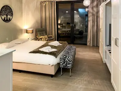 a bedroom with a bed with a zebra blanket on it at Edifício Algarve in Quarteira