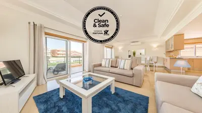 a living room with a couch and a table at Lakeside Country Club - Apartamentos Turísticos in Quinta do Lago