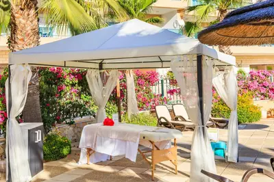 a white tent with a table and chairs under it at Lakeside Country Club - Apartamentos Turísticos in Quinta do Lago