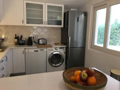 a kitchen with a bowl of fruit on a counter at Villa Zen - beautiful private pool-heating option, hot tub, beautiful garden in Albufeira