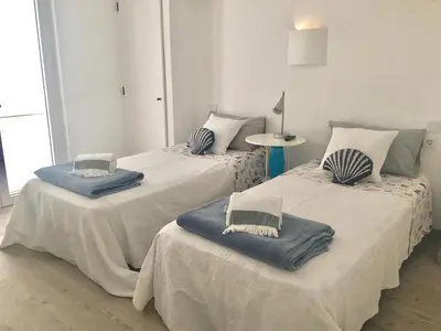 two beds with pillows on them in a room at Villa Zen - beautiful private pool-heating option, hot tub, beautiful garden in Albufeira