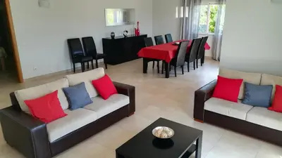 a living room with two couches and a table at Villa 48 in Quarteira