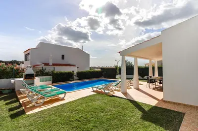 a backyard with a swimming pool and a house at Villa 300m from Beach - By Algarkasa in Albufeira