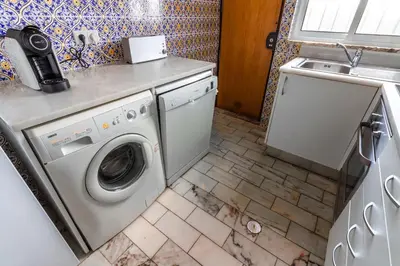 a kitchen with a washing machine and a sink at Villa 300m from Beach - By Algarkasa in Albufeira