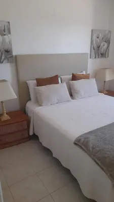 a bedroom with two beds and two lamps on tables at A Apartmento Solar dos Pinheiros in Vilamoura