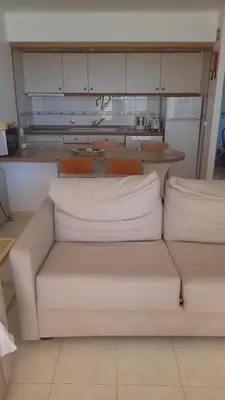 a living room with a couch in a kitchen at A Apartmento Solar dos Pinheiros in Vilamoura