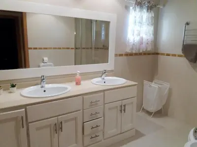 a bathroom with two sinks and a mirror and a toilet at Apartment Coelha Beach - Pool - Free Wi-Fi - Air Con in Albufeira