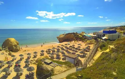a beach with a bunch of umbrellas and the ocean at Apartment Coelha Beach - Pool - Free Wi-Fi - Air Con in Albufeira