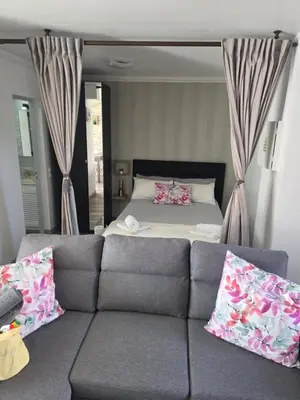 a living room with a couch and a bed at Marina Vilamoura in Vilamoura