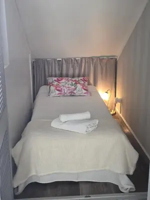 a small bed with a white blanket and a lamp at Marina Vilamoura in Vilamoura