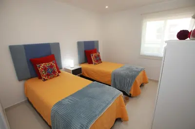 a room with two beds in a room at Apartamento A Palmeira in Albufeira