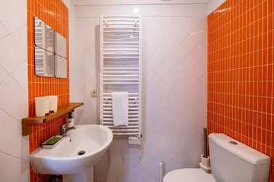 a bathroom with a white toilet and a sink at Vita Portucale ! Quarteira Sea View in Quarteira
